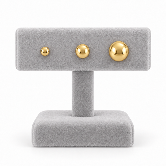 9ct gold plain ball studs in three sizes side by side on a stand
