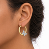 9ct gold butterfly creole earring worn in the ear