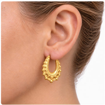 9ct gold oval creole spike earring worn in the ear