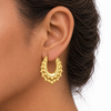 9ct gold oval creole spike earring worn in the ear