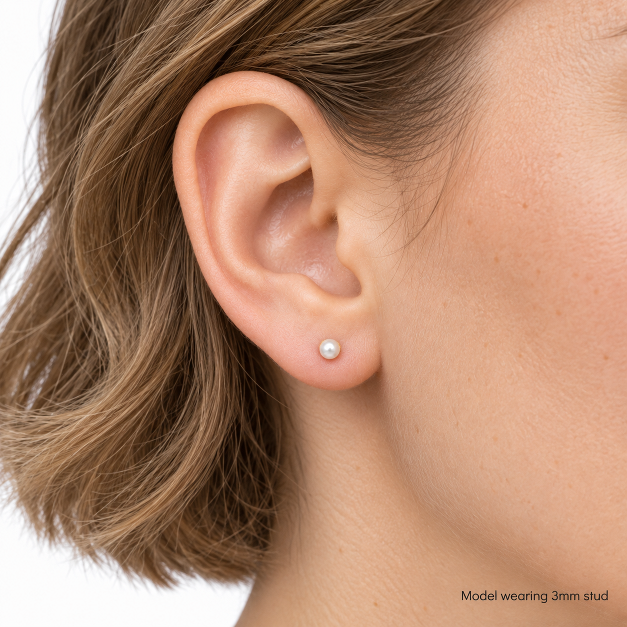 9ct gold pearl stud earring worn in the ear, labelled as the 3mm