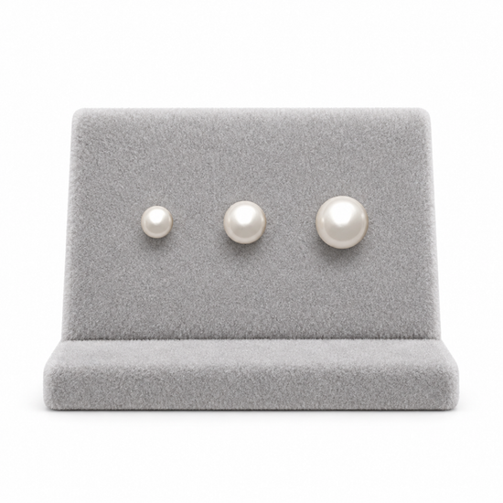 9ct gold pearl studs in three sizes side by side on a stand