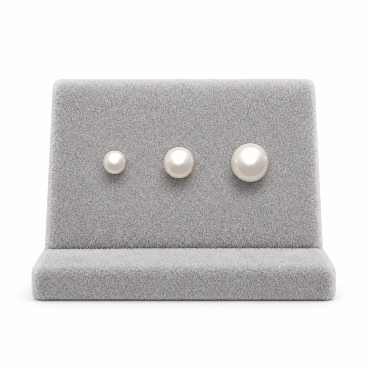 9ct gold pearl studs in three sizes side by side on a stand