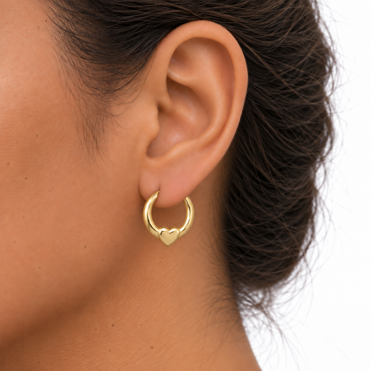 9ct gold round creole with heart earring worn in the ear